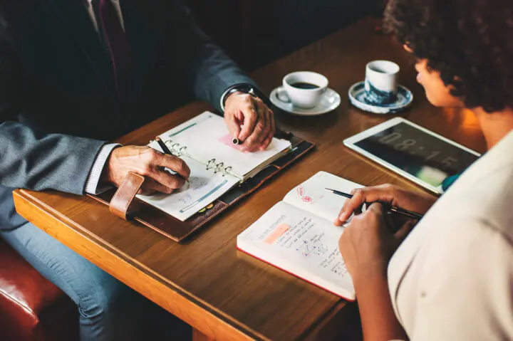 taking notes at a meeting