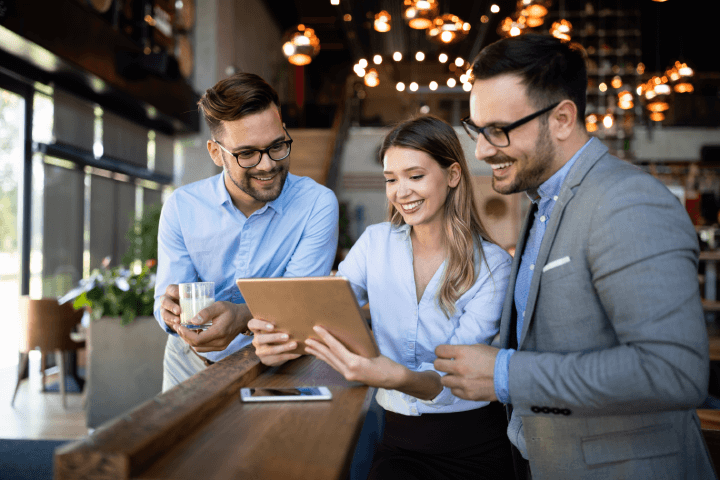 happy-coworkers-watching-tablet-professional-development