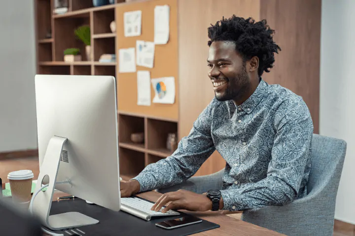 man-smiling-learning-laptop-corporate-training