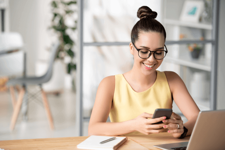 woman-using-phone-computer-challenges-managing-remote-employees