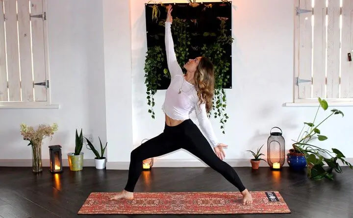 Woman doing yoga while working from home