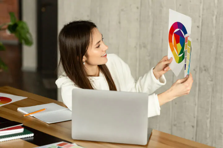 woman showing swatches to her team on video call