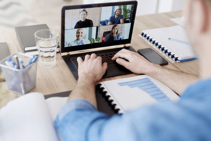 man on video call with colleagues