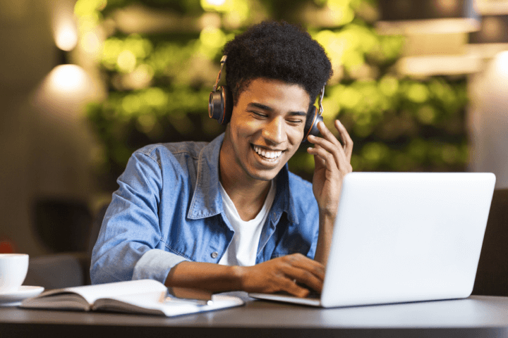 man on video call on laptop with headphones