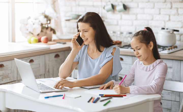 mother works from home next to her daughter