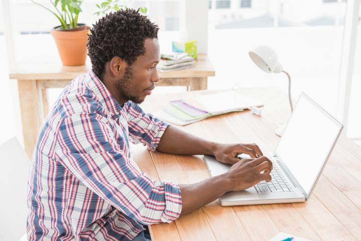 man working remotely on laptop