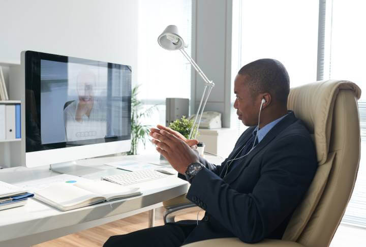 man on video call in his office