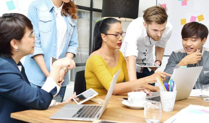 group of workers retraining with laptops