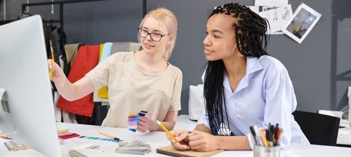 Two women working on computer