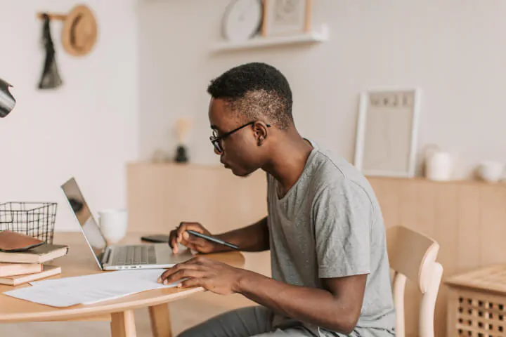 Male remote worker taking a test on laptop