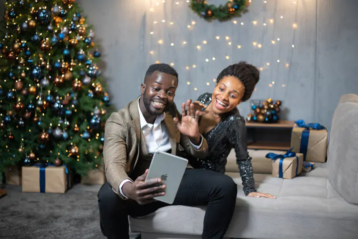 Couple celebrating holidays with remote coworkers