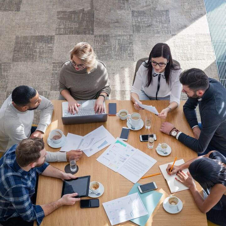 employee meeting at a wood table